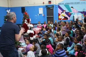 WRAL-FM's Casey Tate and Santa have fun with the kids at the MIX 101.5 Hope for the Holidays event for the Boys & Girls Clubs serving Wake County.